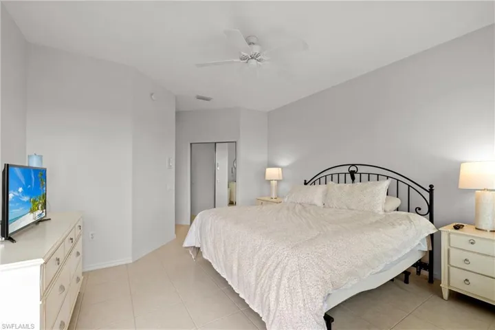 Tiled bedroom featuring a closet and ceiling fan
