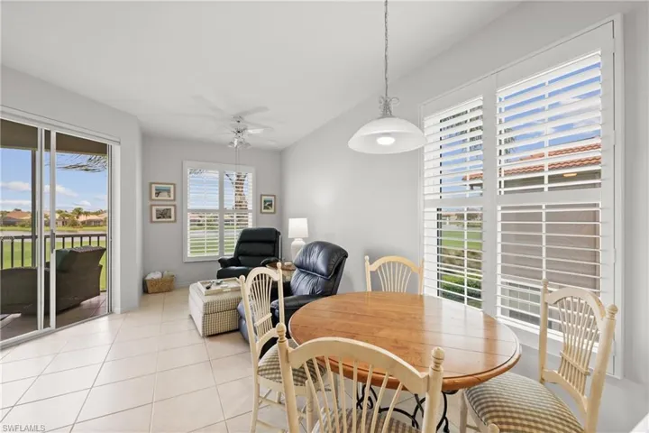 Dining space with ceiling fan and light tile patterned flooring