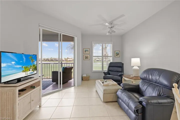 Living room featuring ceiling fan and light tile patterned floors