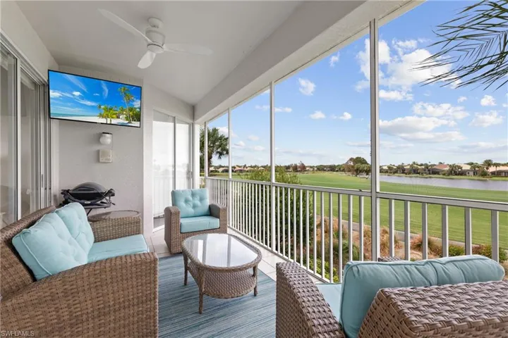 Sunroom / solarium featuring a water view and ceiling fan