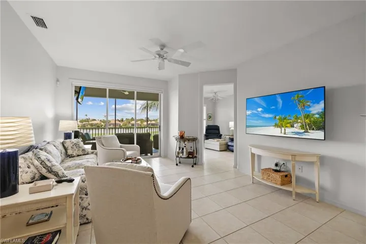 Tiled living room featuring ceiling fan