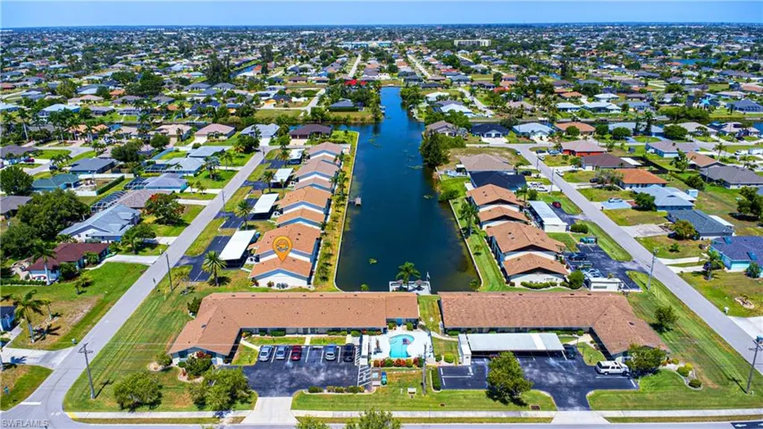 Aerial overview of property's location featuring a large body of water and nearby suburban area