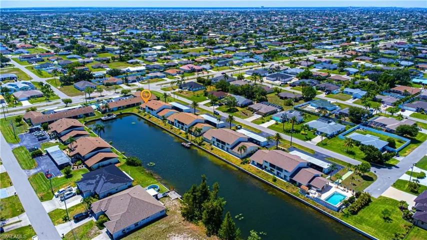 Aerial overview of property's location featuring a large body of water and nearby suburban area