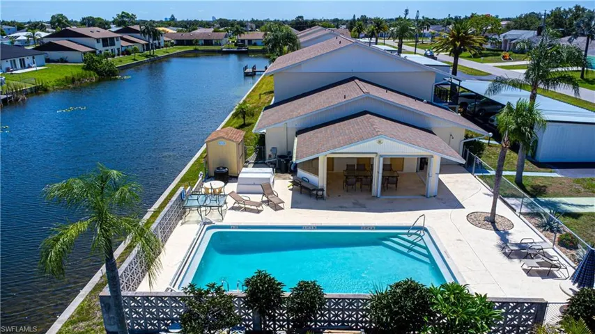 Community pool with a residential view, a patio, and a water view