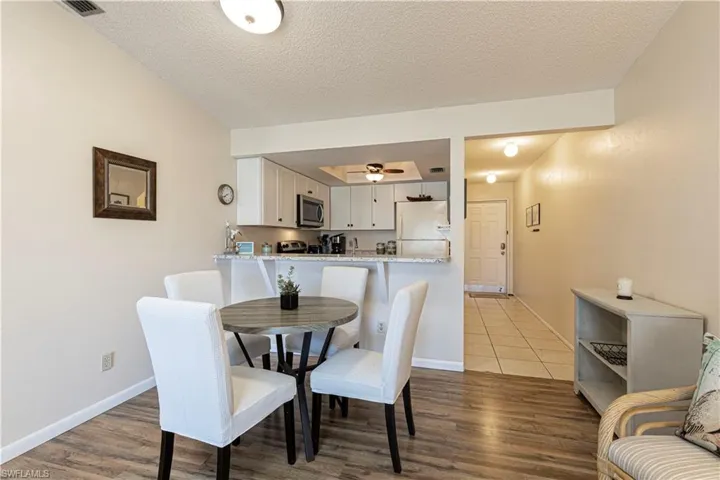 Dining space featuring a textured ceiling and light wood finished floors