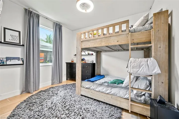 Bedroom featuring wood finished floors and baseboards