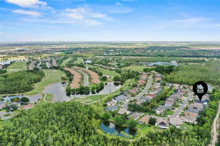 Aerial overview of property's location featuring a nearby body of water and nearby suburban area