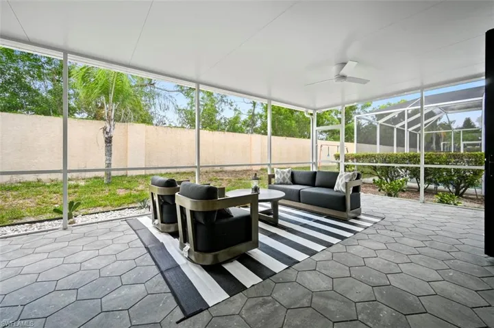 Sunroom with an outdoor living space, a ceiling fan, and plenty of natural light