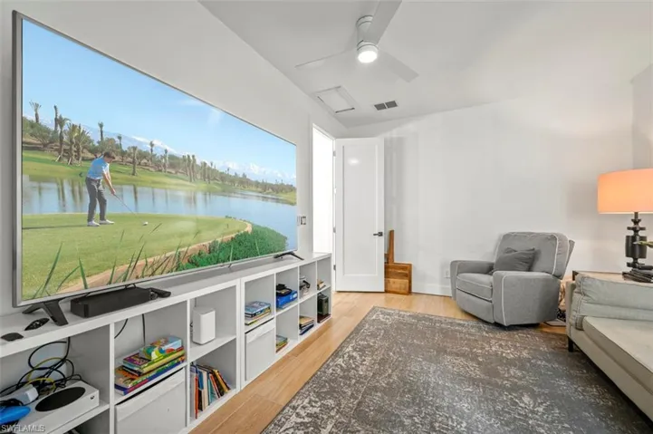 Living area featuring light wood-type flooring and ceiling fan