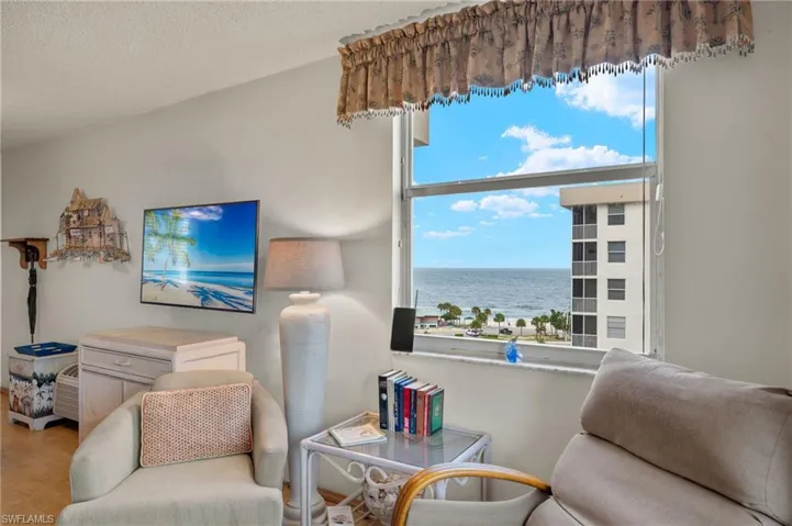 Living room with a textured ceiling and hardwood / wood-style flooring