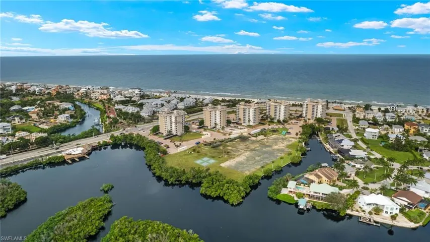 Birds eye view of property with a water view
