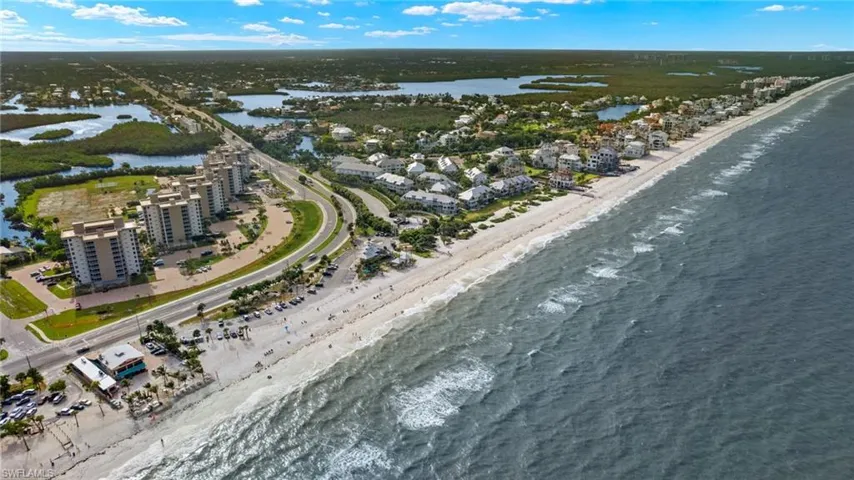 Bird's eye view featuring a water view and a beach view