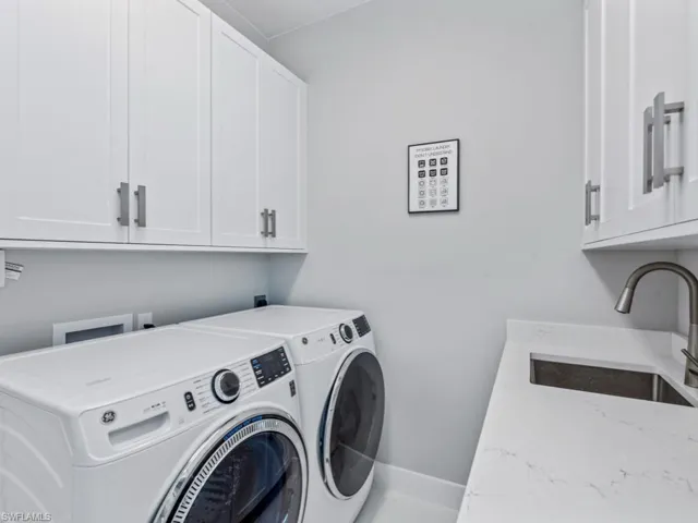 Laundry room featuring washing machine and dryer and cabinet space