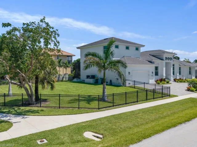 View of front of property featuring stucco siding and decorative driveway