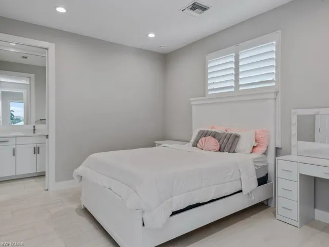 Bedroom with recessed lighting and ensuite bath