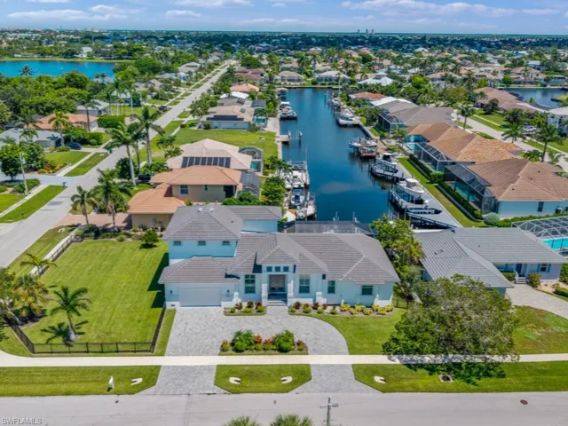 Aerial view of residential area featuring a nearby body of water