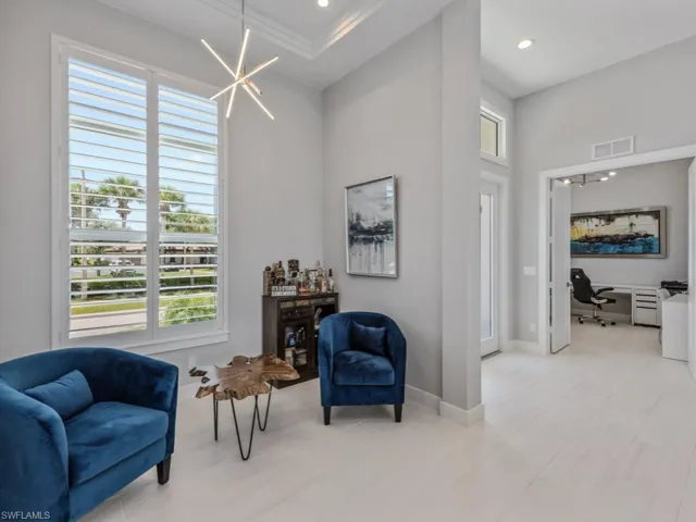 Living area featuring a desk, a chandelier, and recessed lighting