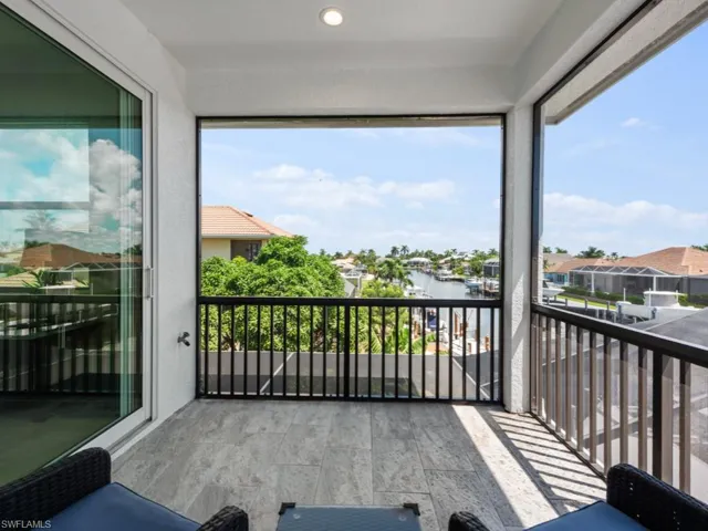 Balcony with a sunroom and a water view