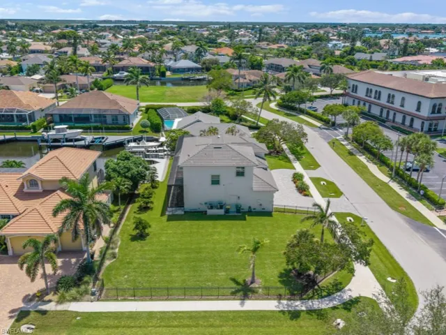 Aerial perspective of suburban area with a nearby body of water