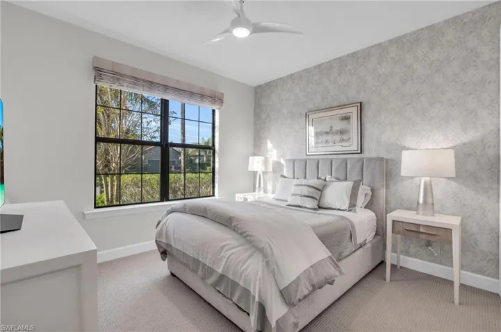 Bedroom with light carpet and ceiling fan