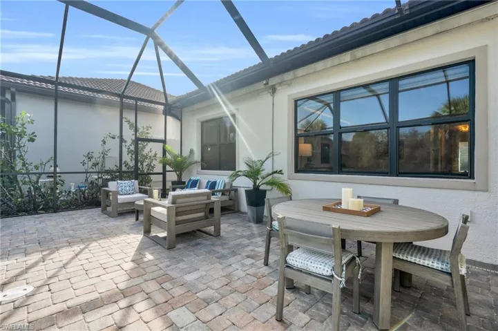 View of patio featuring an outdoor hangout area and glass enclosure