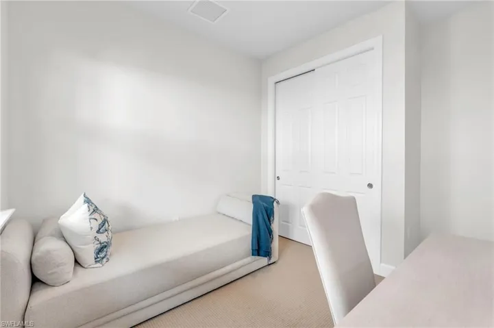 Carpeted bedroom featuring a closet