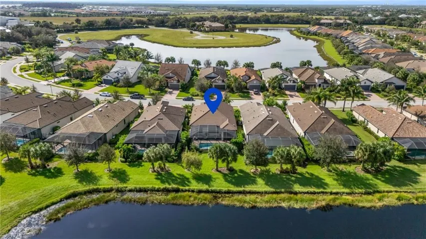 Birds eye view of property with a water view