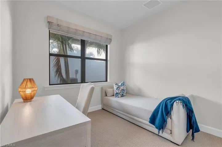 Bedroom with light colored carpet