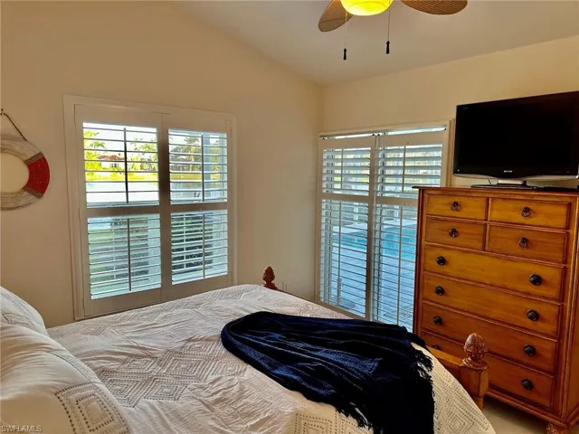 Bedroom featuring vaulted ceiling and a ceiling fan