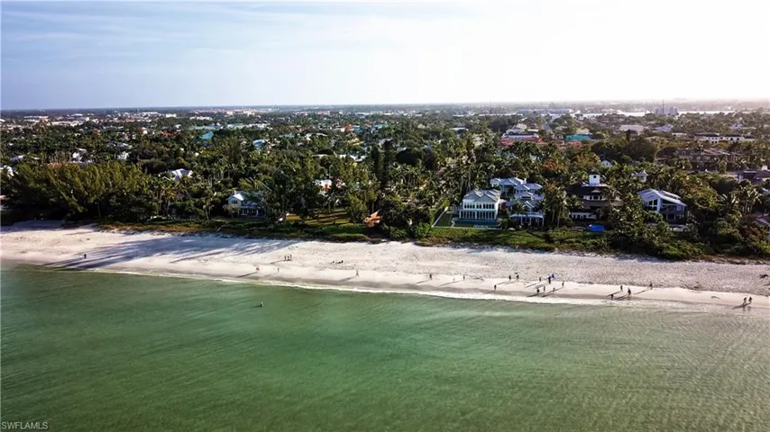Aerial view of residential area with waterfront with a beach