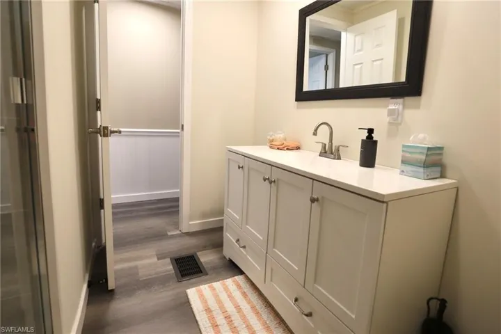 Bathroom with hardwood / wood-style flooring and vanity
