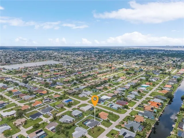 Aerial perspective showcasing a residential area with a prominent canal system