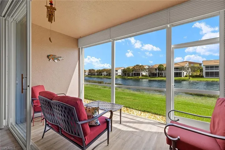 Sunroom / solarium with a water view