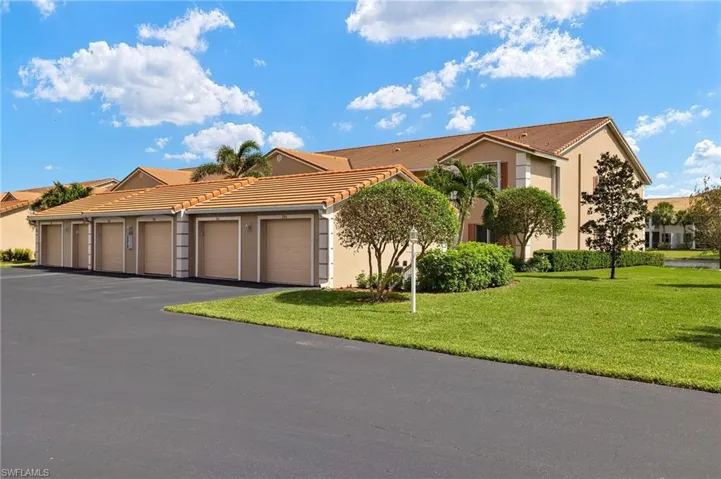 View of front of home with a front lawn and a garage