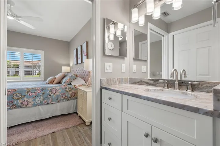 Bathroom with vanity, hardwood / wood-style floors, and ceiling fan