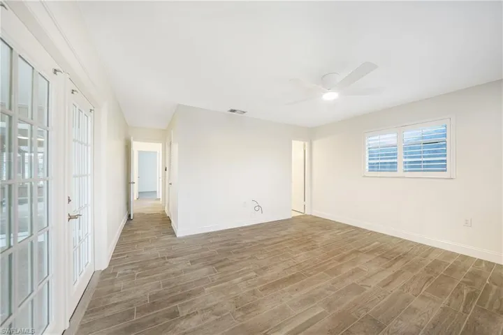 Unfurnished room with wood-type flooring and ceiling fan