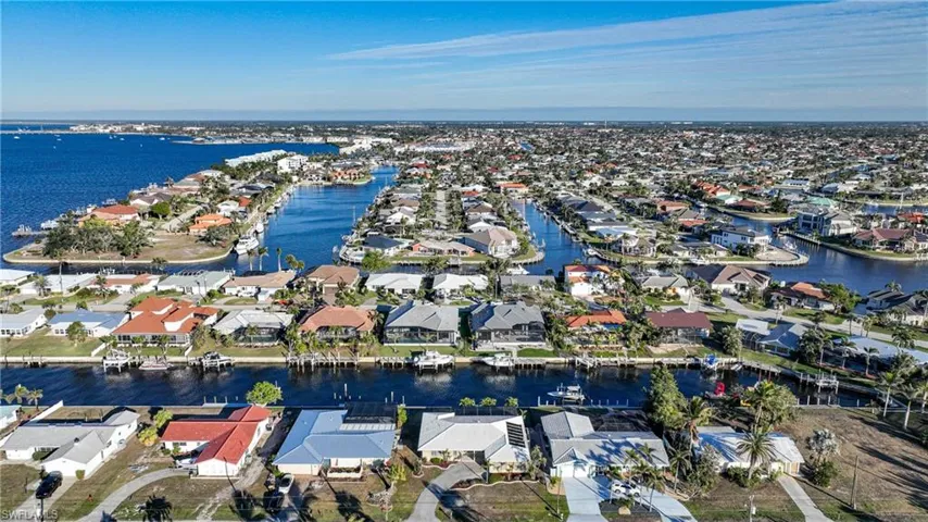 Birds eye view of property with a water view