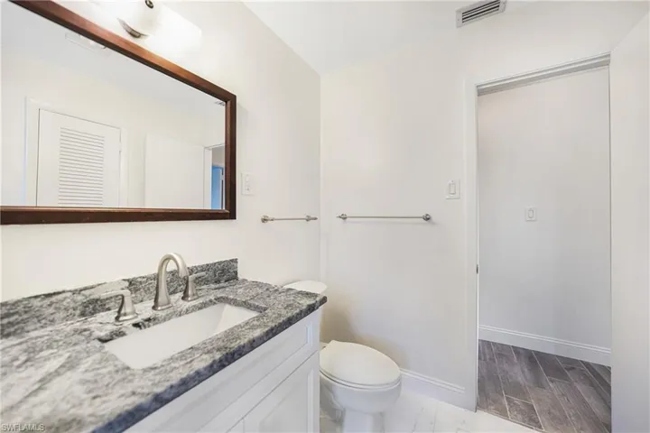 Bathroom featuring vanity and toilet
