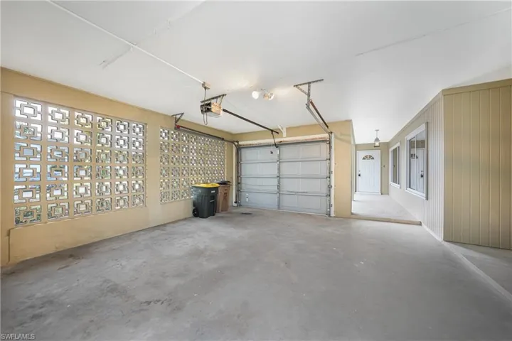 Garage with a garage door opener and wooden walls