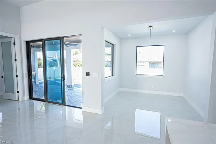Spare room featuring a healthy amount of sunlight, baseboards, and recessed lighting