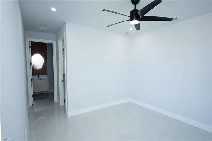 Empty room featuring recessed lighting, visible vents, baseboards, and a ceiling fan