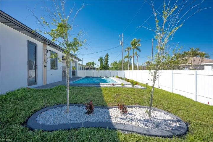 View of yard with a fenced in pool and a fenced backyard