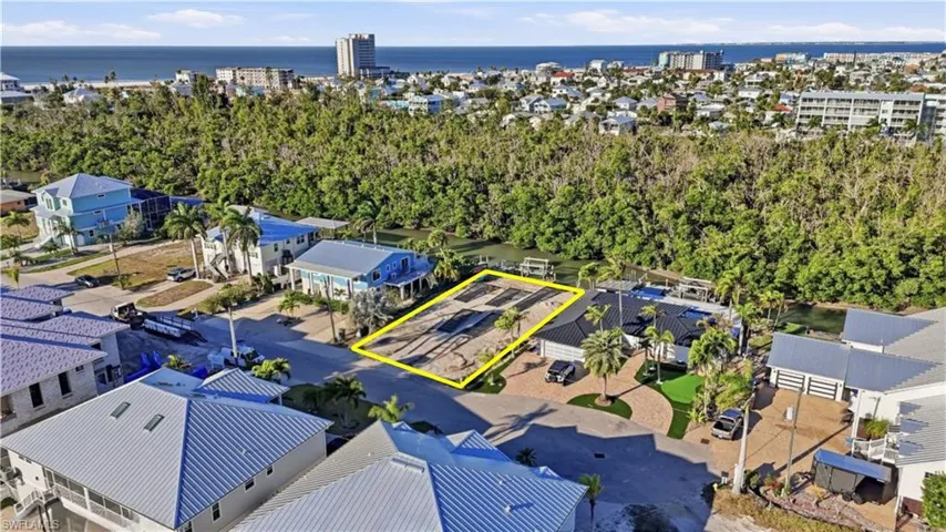View of property location with property parcel outlined and a large body of water - Virtually Edited Image