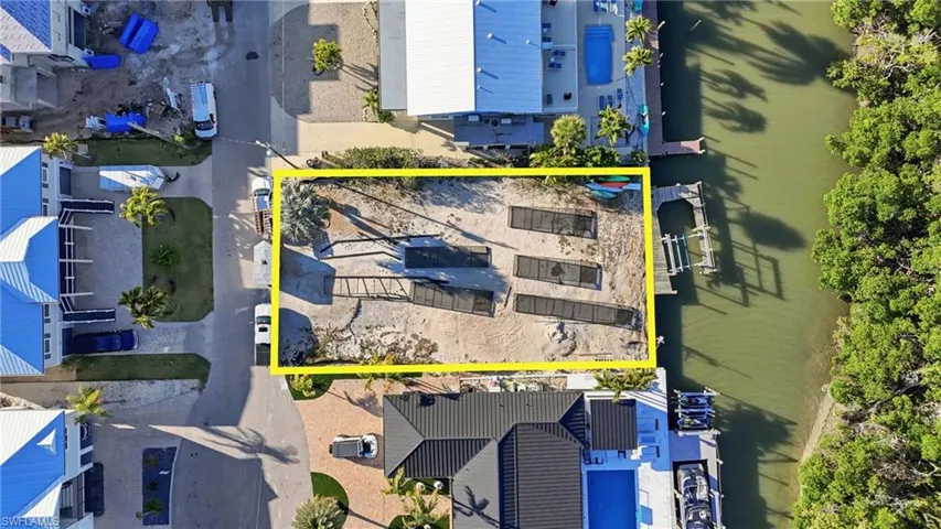 Aerial view of property and surrounding area featuring property parcel outlined - Virtually Edited Image