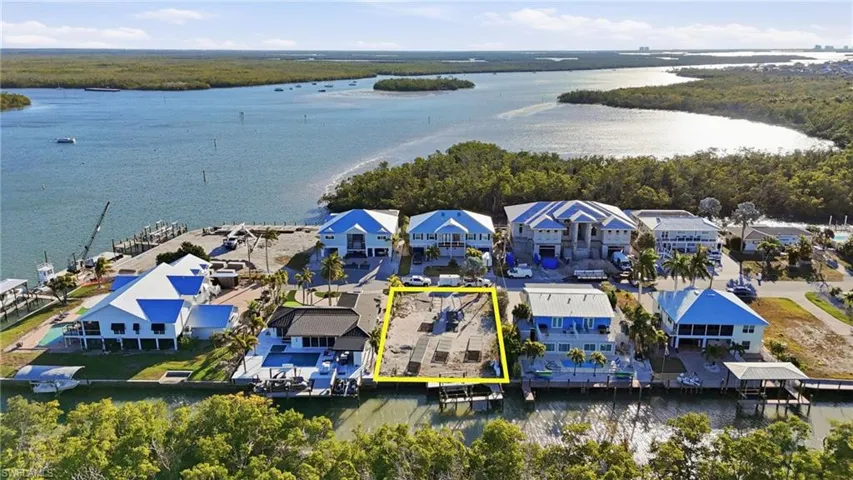 Aerial overview of property's location featuring property parcel outlined and a large body of water - Virtually Edited Image