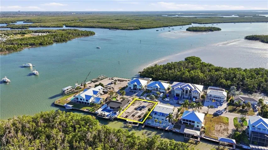 View of property location with property parcel outlined and a nearby body of water - Virtually Edited Image