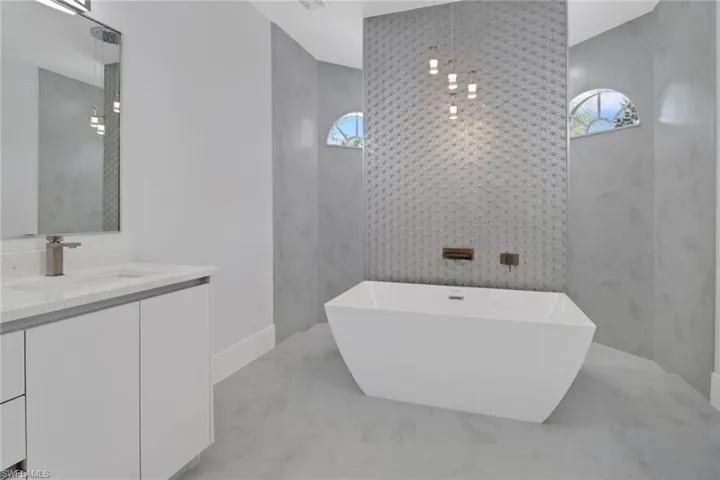 Bathroom featuring vanity and a washtub