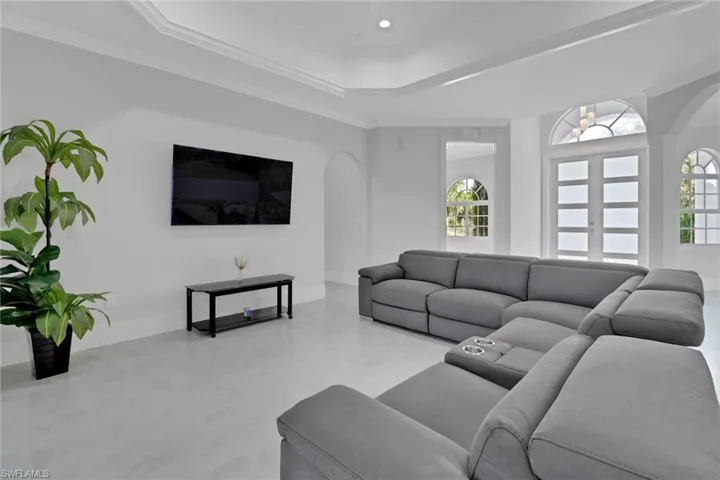 Living room featuring crown molding and a tray ceiling
