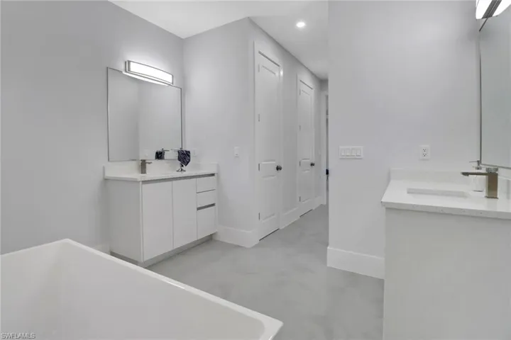 Bathroom featuring vanity and a bath