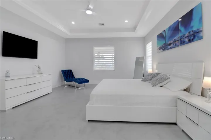 Bedroom featuring ceiling fan and a raised ceiling